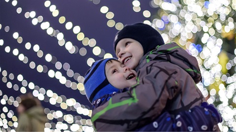 two-boys-hug-under-strings-of-holiday-lights2.jpg
