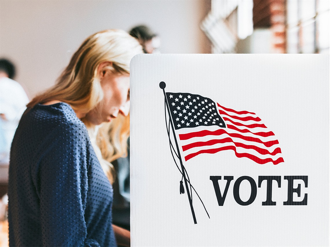 Woman-stands-and-votes-at-vote-center.jpg