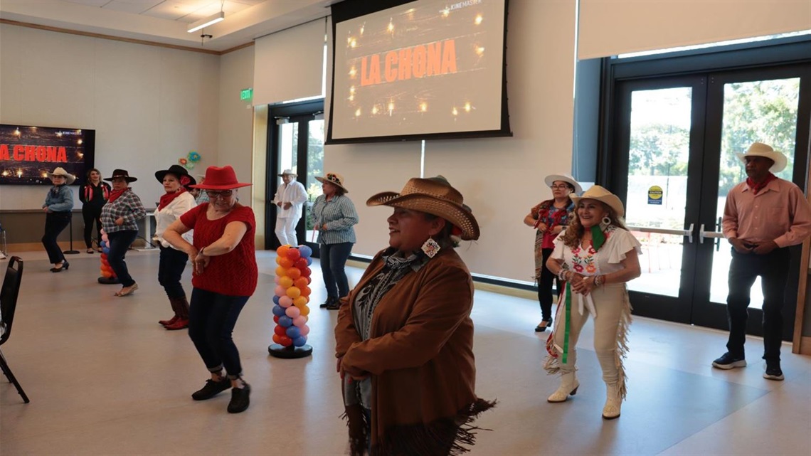 People dancing with cowboy hats on