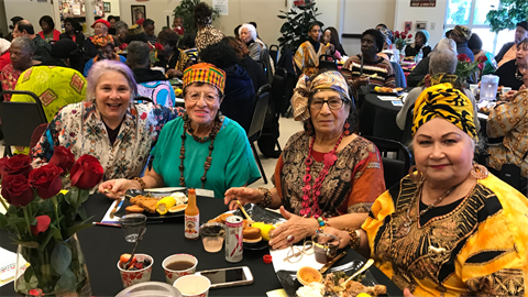 Senior Special Event Luncheon ladies smile for picture in festive attire