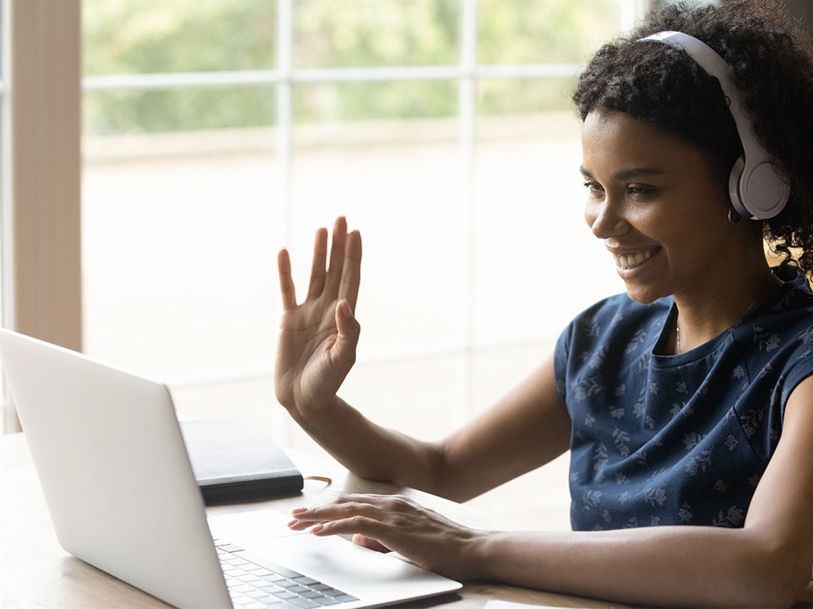 teen-girl-waves-while-using-laptop-computer.jpg