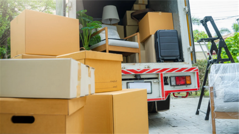 moving truck with items stacked around it