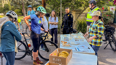 bikers stopping at a booth for snacks