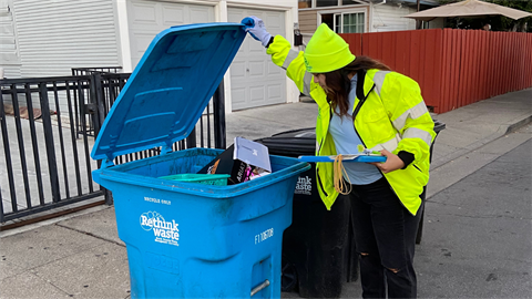Recology staff checking waste bins