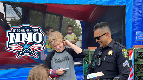 National Night Out logo with officer and children