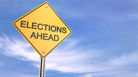 Elections ahead on street sign with sky background