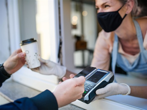 Barista-serves-to-go-coffee-and-accepts-credit-card-payment.jpg