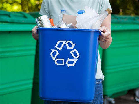 Man-bringing-recycling-can-to-bins.jpg
