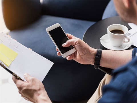 Man-uses-mobile-phone-to-schedule-appointment.jpg