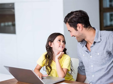 father-observes-as-daughter-safely-uses-laptop